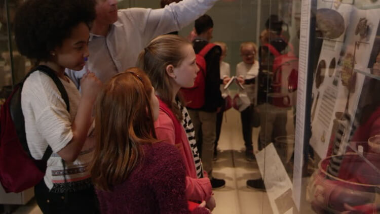 kids in a museum looking at items
